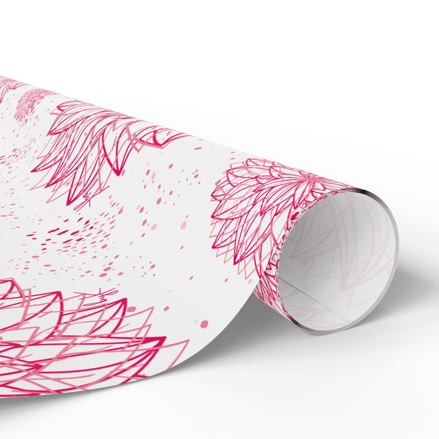 A close-up of a partially rolled sheet of Designed byKath.com Pink and white floral Wrapping Paper in various sizes from the brand byKath, set against a white background. The high-definition print features intricate red and pink floral patterns with overlapping petal shapes and small scattered dots, creating an elegant and decorative look.